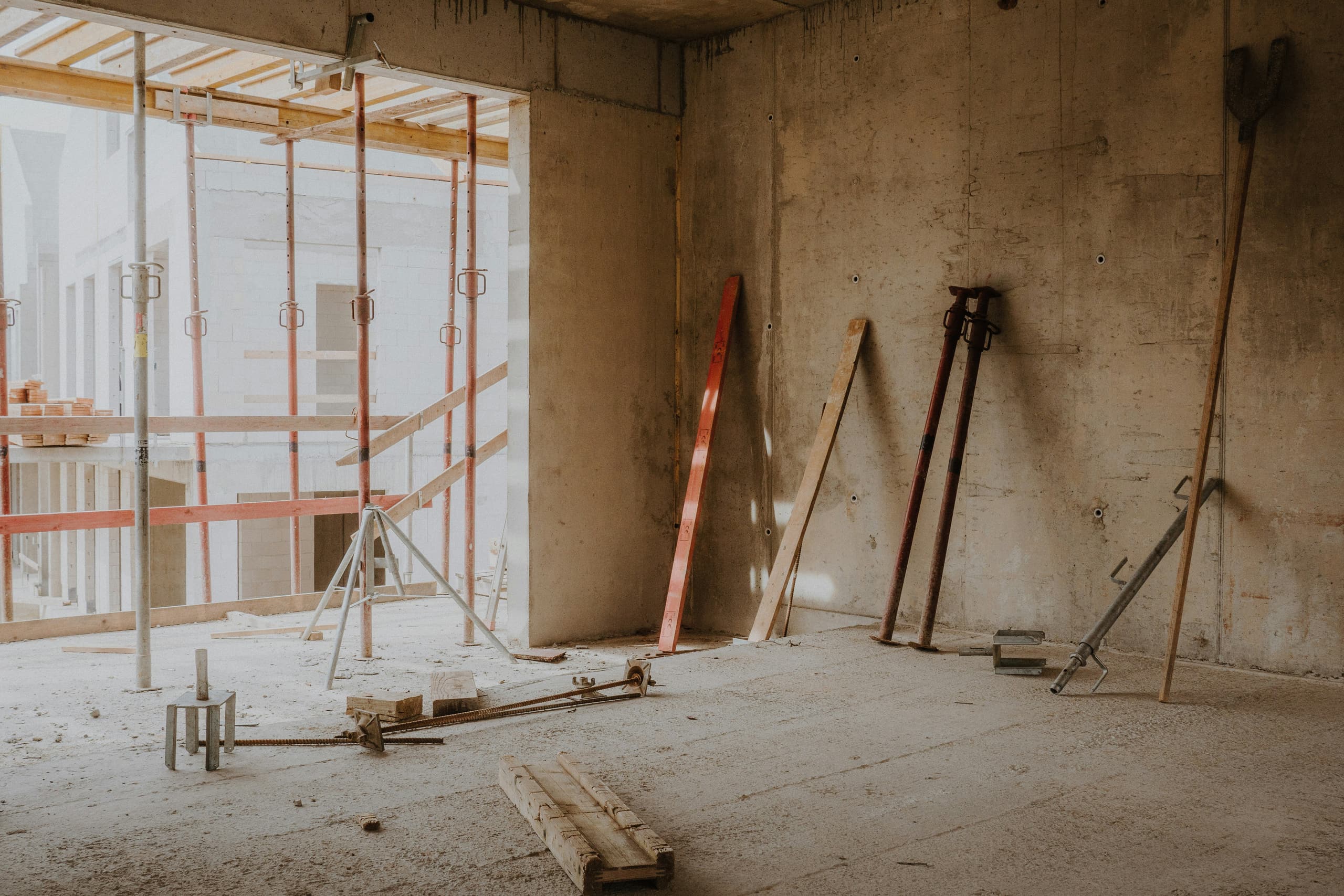 A new-build interior with timber offcuts and props, waiting on its post-construction clean