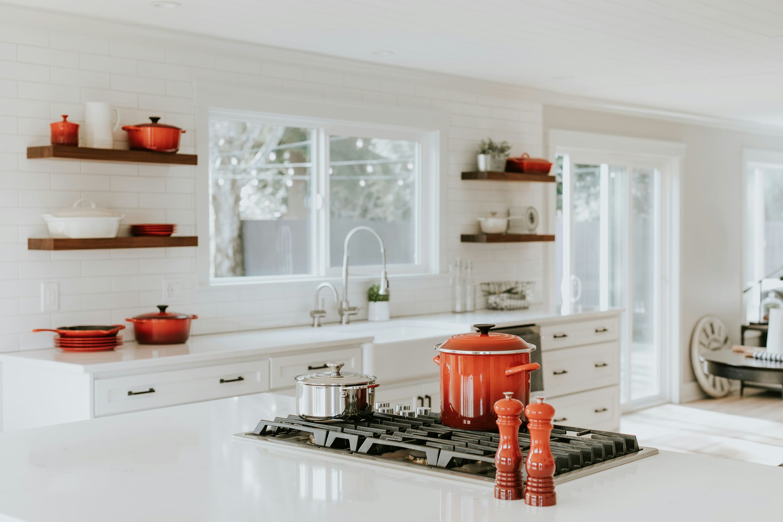 A bright white kitchen with clean tiled splashback