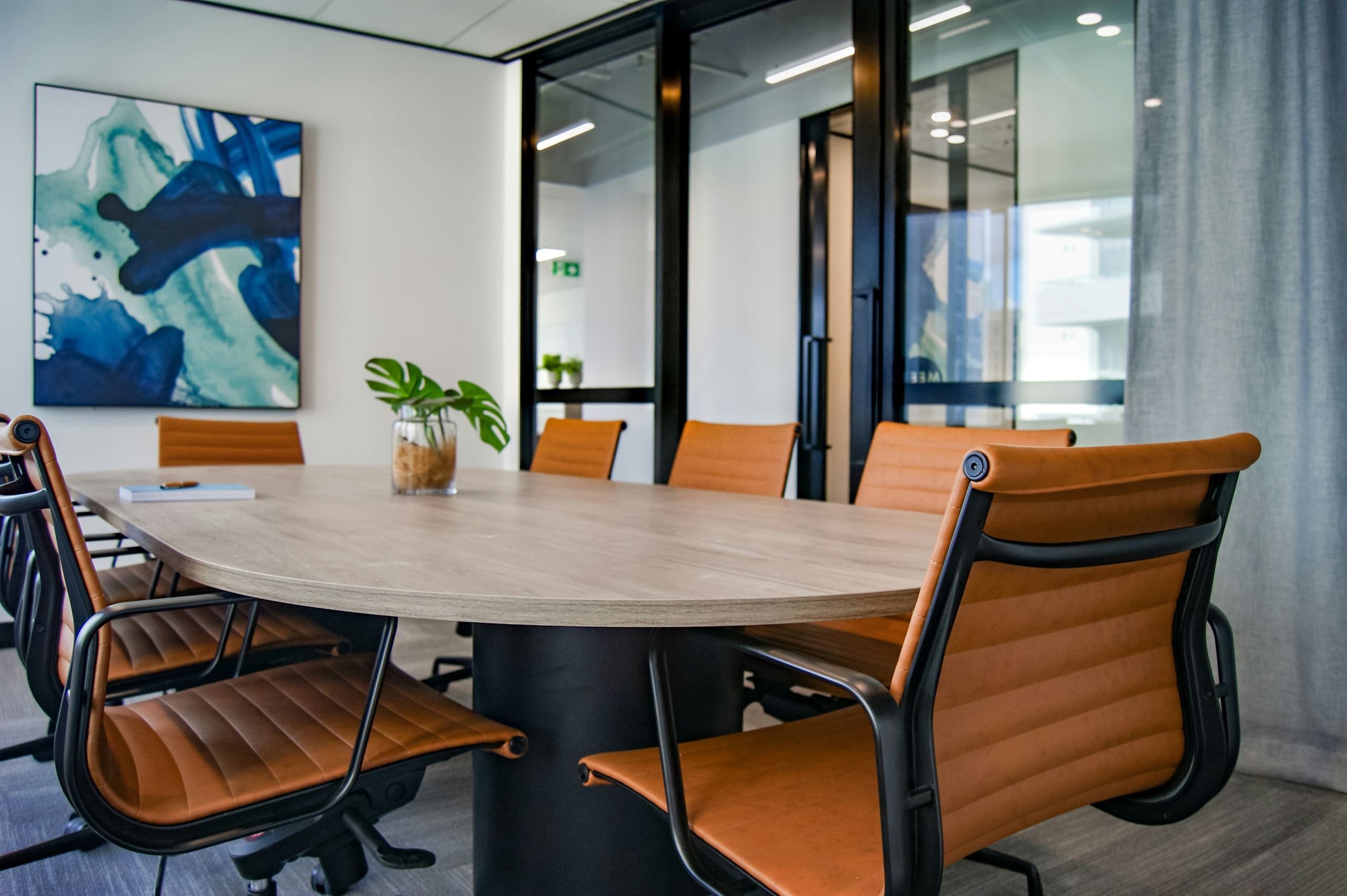 A clean, prepared boardroom with leather chairs