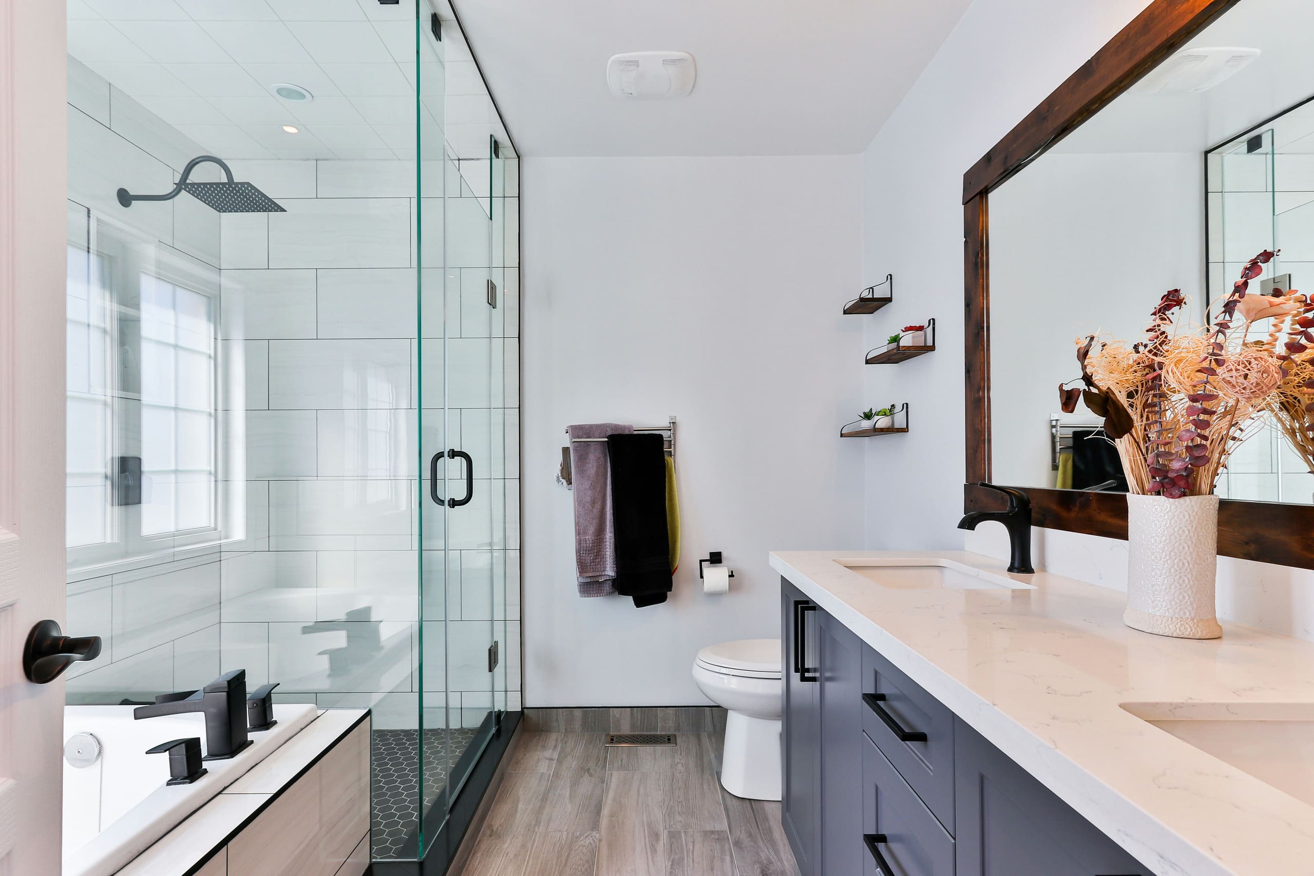 A spotless modern bathroom with glass shower screen