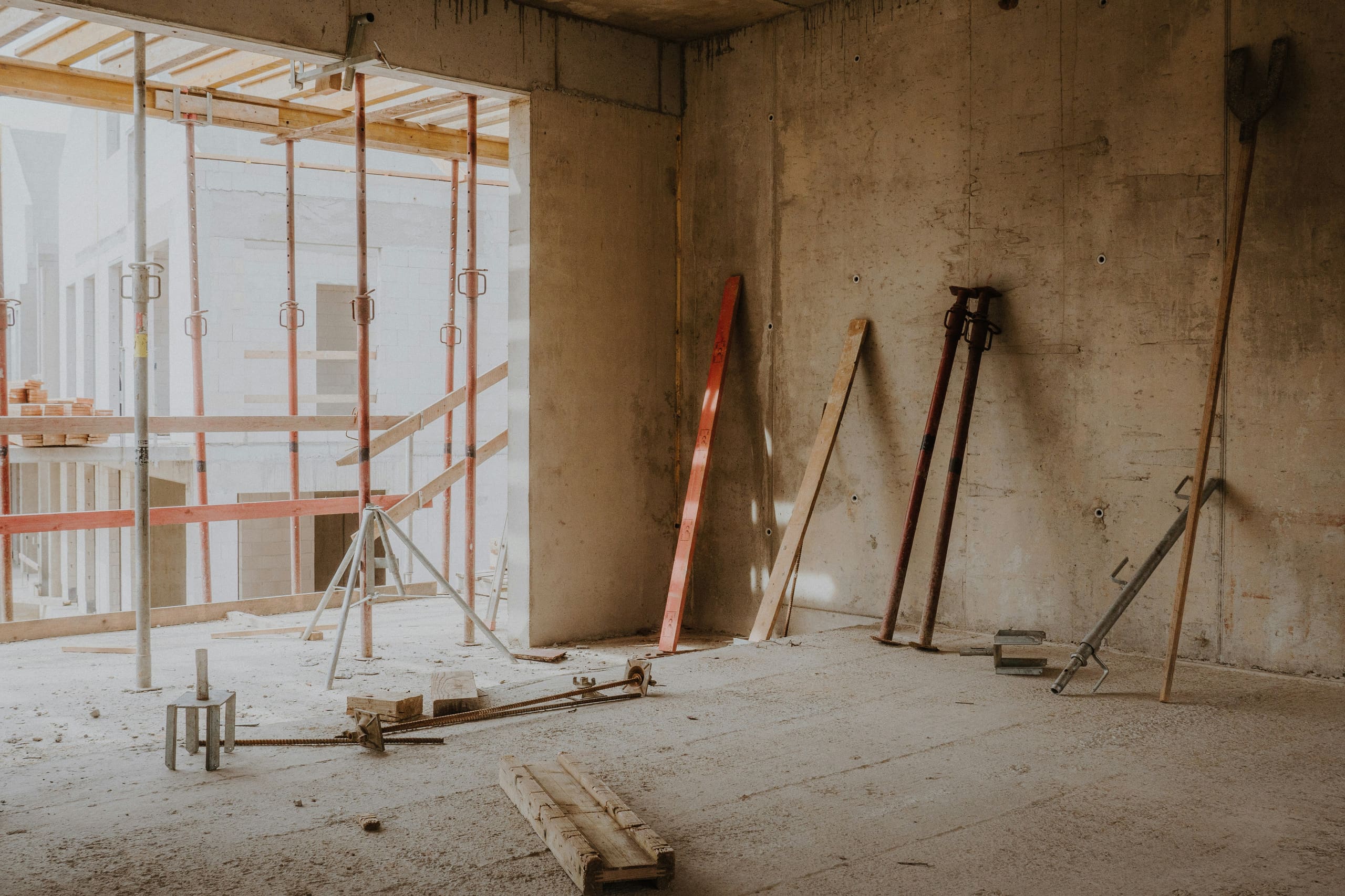 A new-build interior with timber offcuts and props, waiting on its post-construction clean